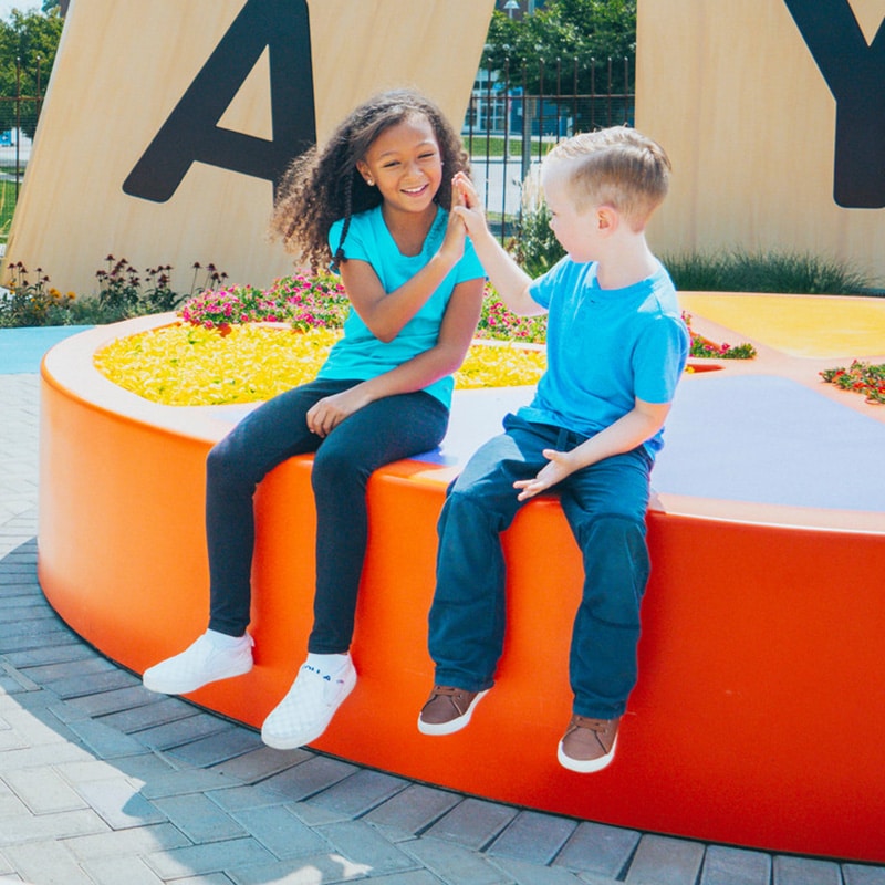 Two kids in Hasbro Game Park giving a high five