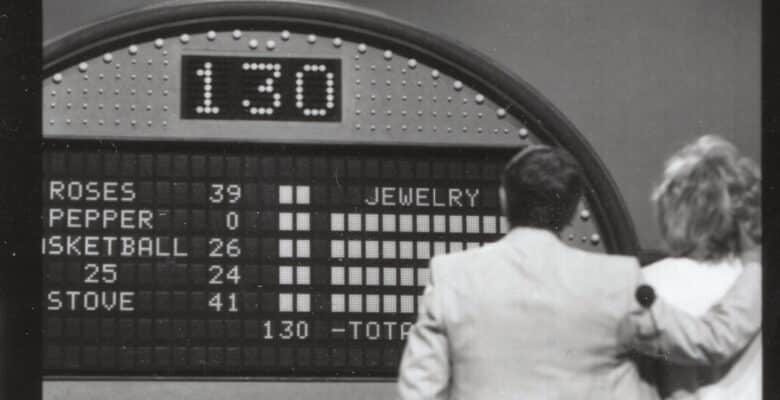 Host looking at the Family Feud survey board results