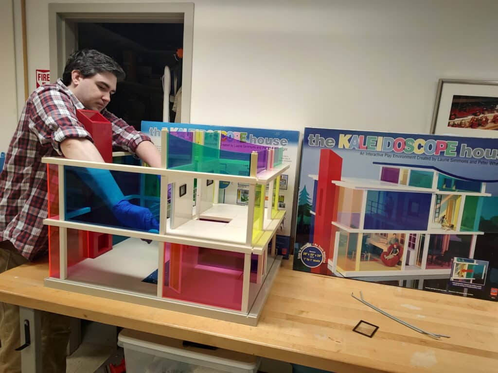 Assembling a new dollhouse in preparation for an upcoming exhibit. 