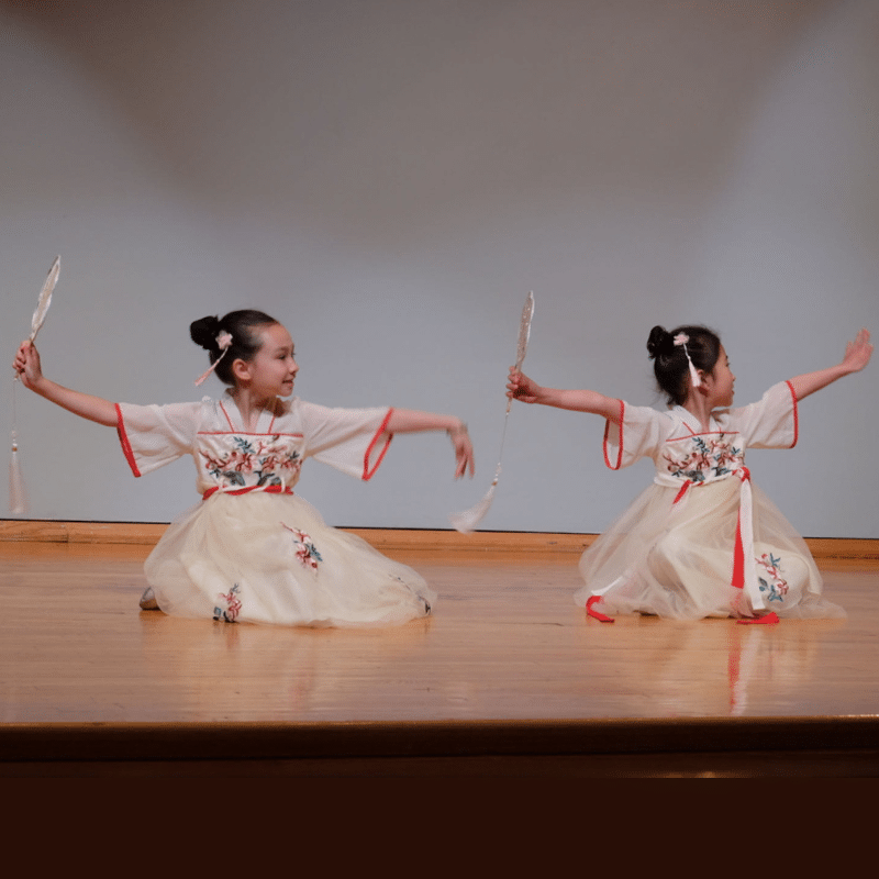 Two young dancers posing on stage