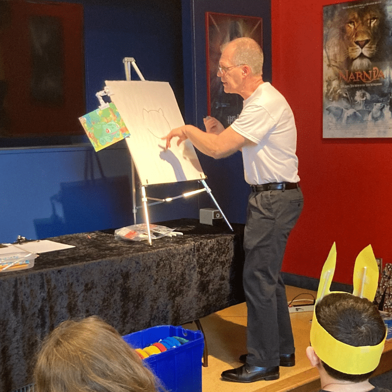 Scott Gibala-Broxholm teaching guests how to draw Pokémon.