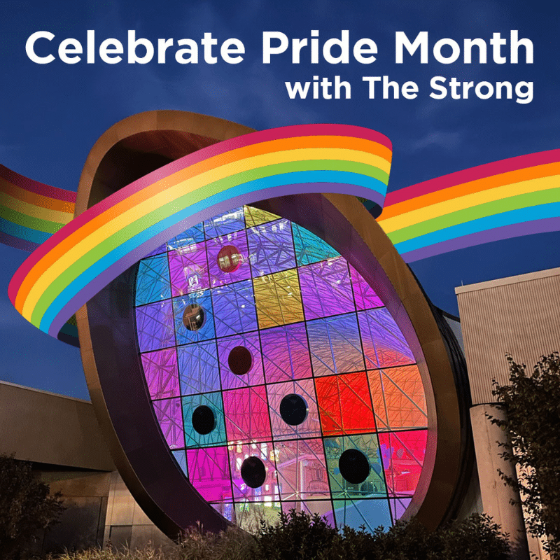 Colorful windows of the Adams Atrium with a rainbow ribbon and text reading "Celebrate Pride Month with The Strong"